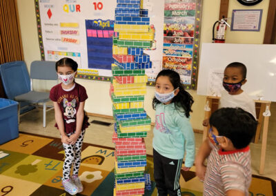 Preschoolers build a tower of blocks